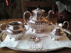 An ANTIQUE SILVER PLATED SELF POURING TEAPOT SET AND TRAY JAMES DIXON