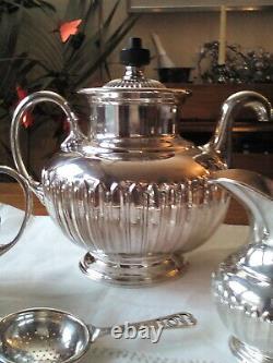 An ANTIQUE SILVER PLATED SELF POURING TEAPOT SET AND TRAY JAMES DIXON