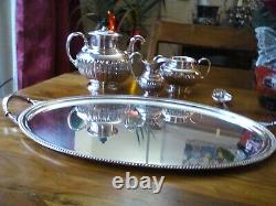 An ANTIQUE SILVER PLATED SELF POURING TEAPOT SET AND TRAY JAMES DIXON