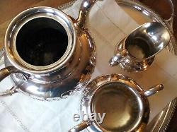 An ANTIQUE SILVER PLATED SELF POURING TEAPOT SET AND TRAY JAMES DIXON