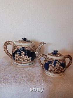 Antique ceramic tea pot and sugar bowel with emblem of man woman baby kid
