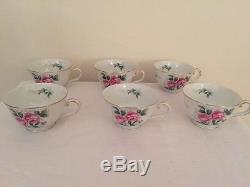 Tea Cups and saucers with matching creamer